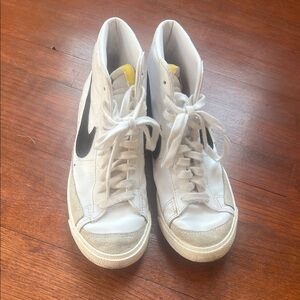 Nike White High-Top Sneakers with Black Swoosh and Yellow Tongue